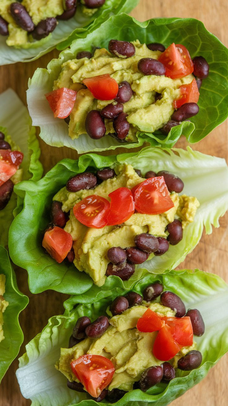 Fresh avocado and black bean lettuce wraps topped with diced tomatoes