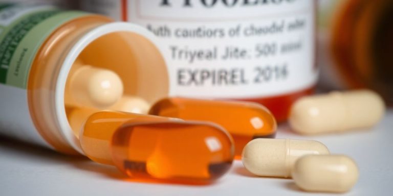 Probiotic capsules with an expiration date label.