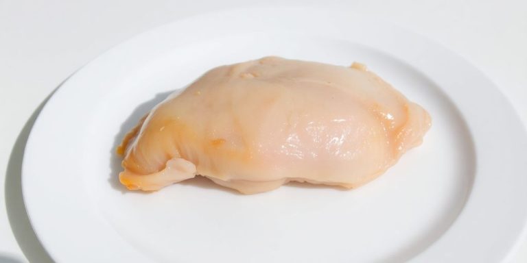 Cooked chicken breast on a plate.